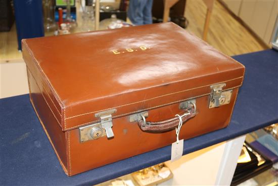 A leather travelling toilet case containing four late Victorian silver mounted jars and thirteen tortoiseshell mounted items.